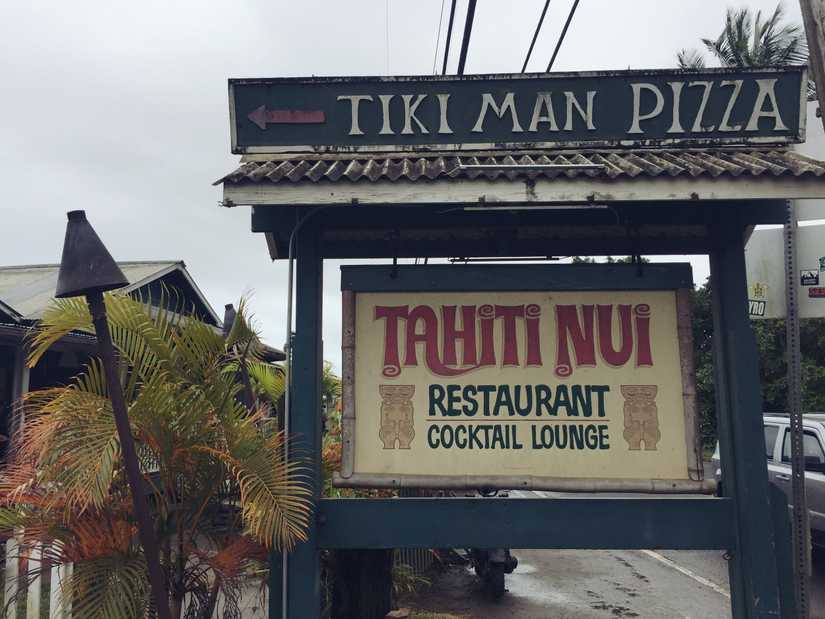 A large free standing sign by a restaurant reading "Tahiti Nui Restaurant Cocktail Lounge"