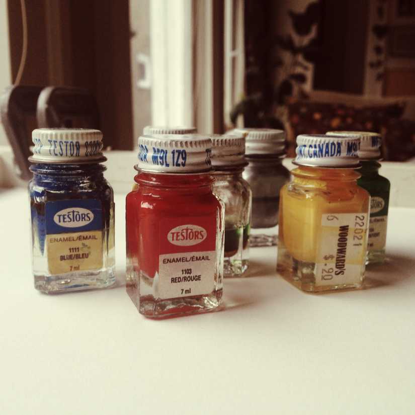 Small bottles of calligraphy ink in blue, red, yellow, and green