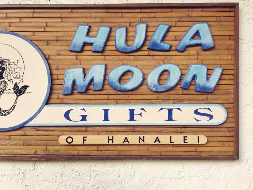 Large wooden cut out sign that reads "Hula Moon Gifts of Hanalei" 