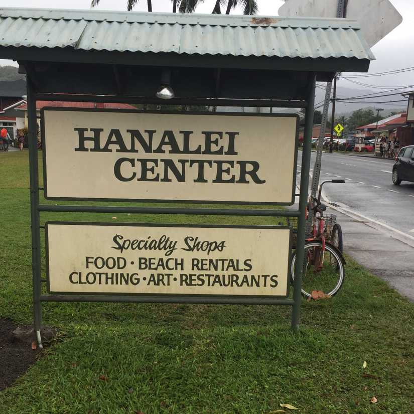large hand painted sign that reads: Hanalei Center, Specialty Shops: Food, Beach, Rentals, Clothing, Art, Restaurants