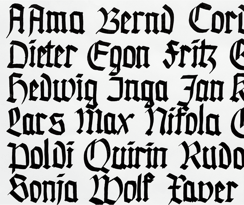 A scan of Blackletter style calligraphy. Dark black ink on white paper.